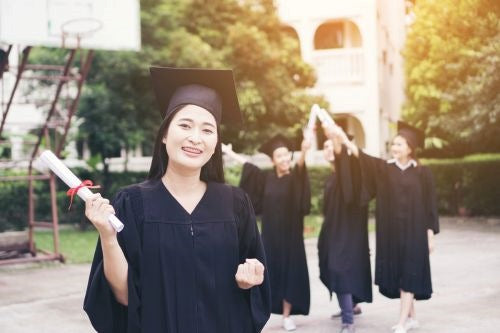 a group of friends graduating happily with the diploma certification and ropes on them,